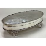 A large jewellery box with hinged lid on feet.