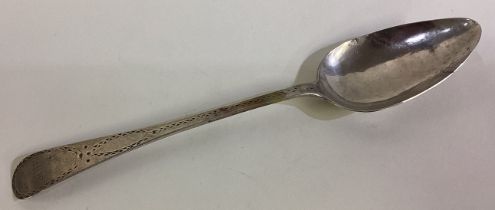 A Chinese trade silver spoon with bright-cut decoration.