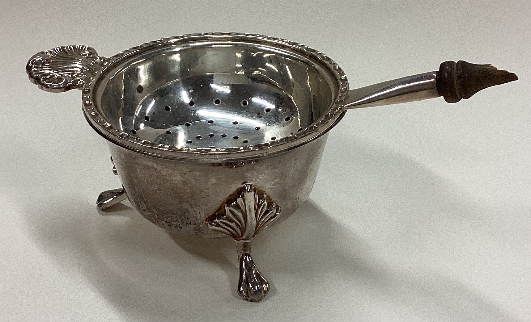 A silver tea strainer on stand. Birmingham 1989.