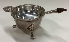 A silver tea strainer on stand. Birmingham 1989.