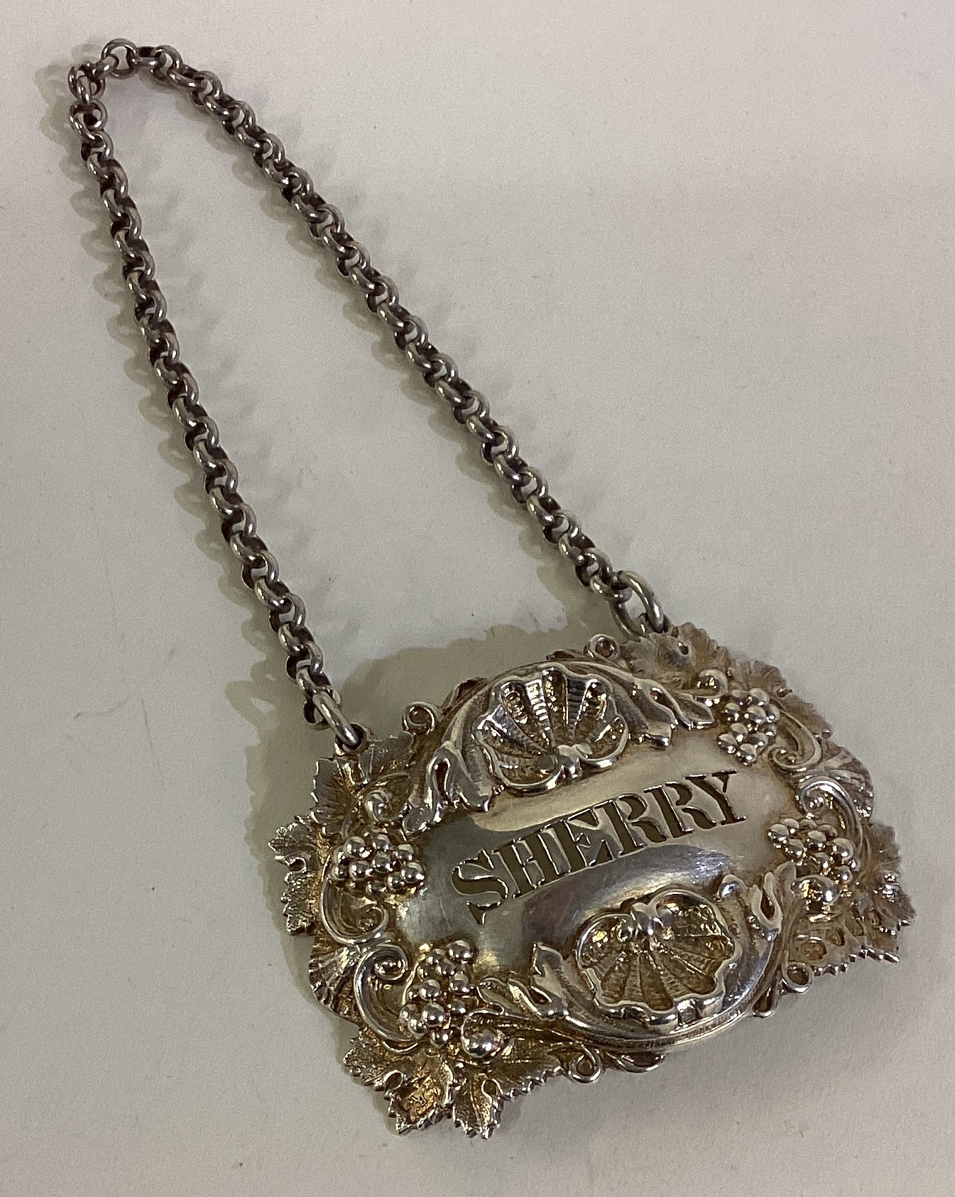 A heavy Victorian cast silver wine label for 'Sherry'.