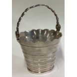 A silver cream pail in the 18th Century style.