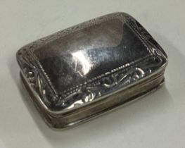 A silver pill box with hinged lid.