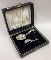 A child's silver pusher and spoon.