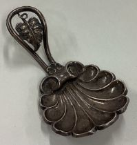 A Victorian silver caddy spoon with cast leaf handle.