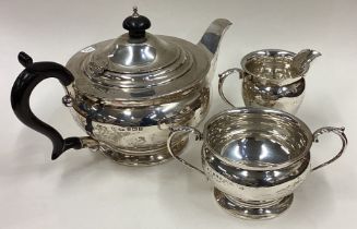 A good circular silver three-piece tea set on pedestal bases.