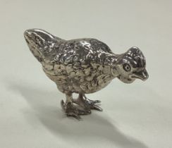 A Sterling silver figure of a chicken.
