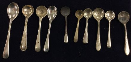 A large group of silver OE pattern salt spoons.