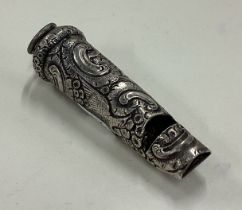 A Victorian silver whistle with chased decoration.