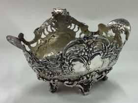 A chased silver basket with pierced decoration.