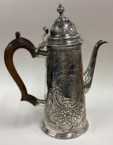 A large 18th Century silver coffee pot with chased decoration.