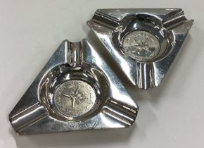 A rare pair of Persian silver ashtrays / dishes inset with coins.