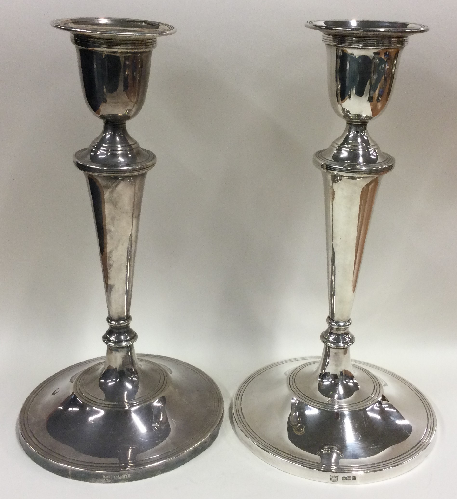 A large pair of silver candlesticks in the Georgian style.