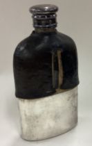 A silver plated and glass flask with screw-top lid.