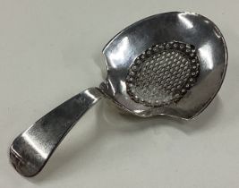 A George III silver caddy spoon with pierced decoration.