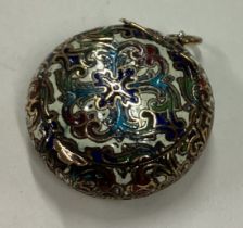 An Antique metal and enamelled box with hinged lid.