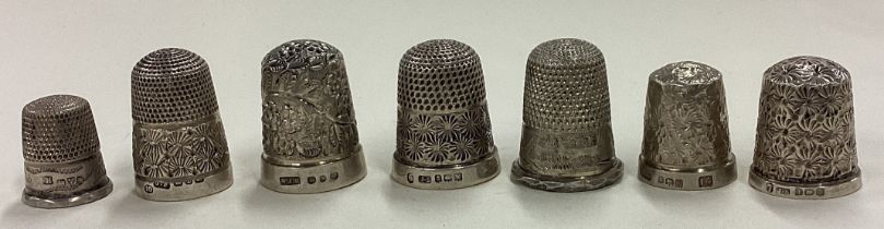 A mixed lot of chased silver thimbles.