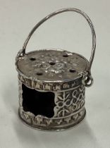 A Dutch silver table toy of a swing handled box.