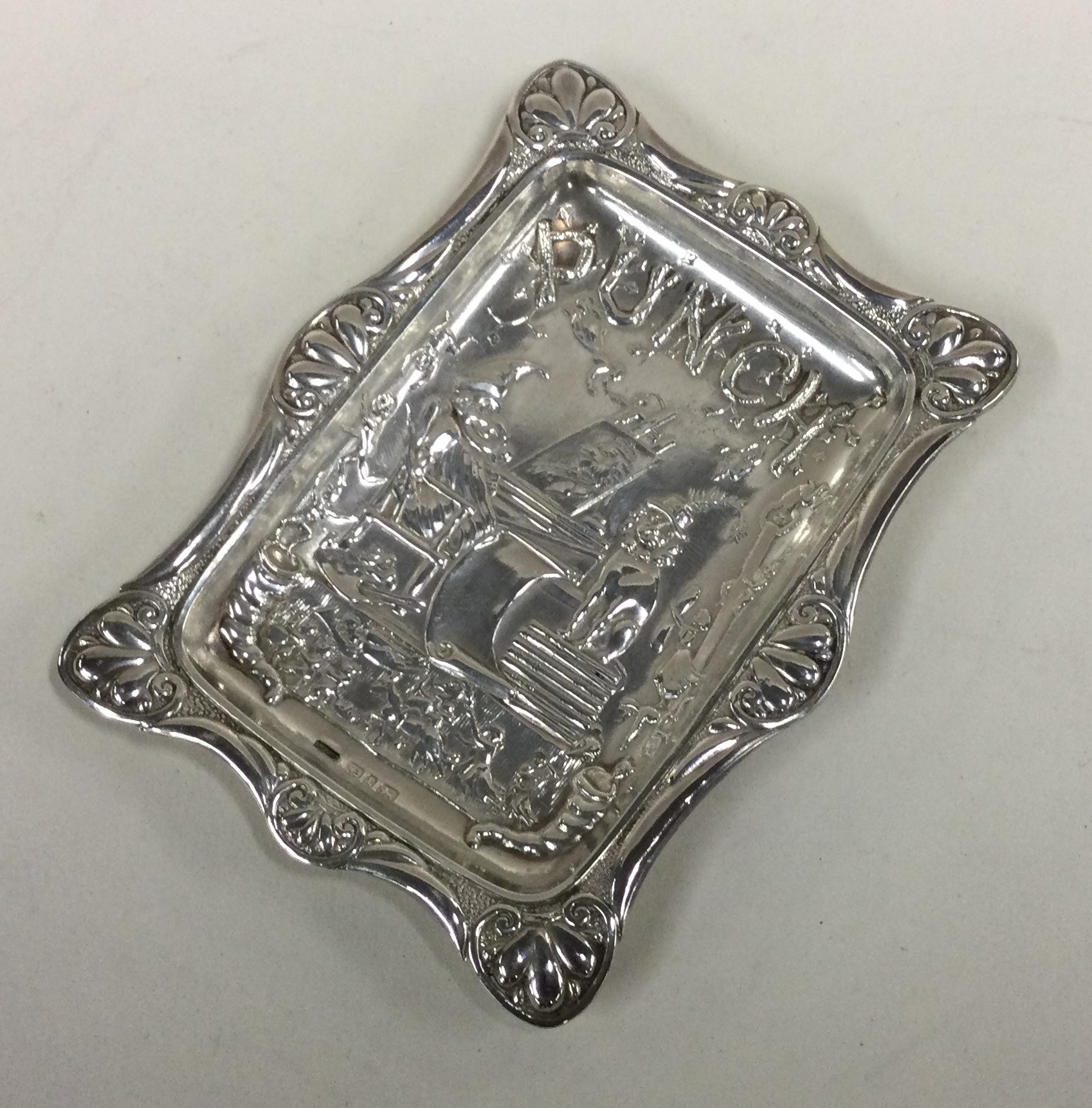 A Victorian silver dish with chased Punch & Judy decoration.