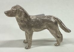 A silver figure of a dog.