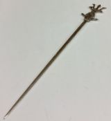 A Victorian silver skewer with sea creature design to handle.