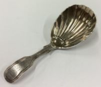 A Victorian silver caddy spoon with fluted bowl.