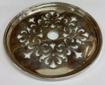 TIFFANY & CO: An oversized silver tea strainer.