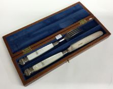 A cased silver and MOP knife and fork.