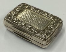 A good George III silver vinaigrette with grape and vine decoration.