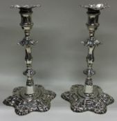 A good pair of 18th Century George III silver candlesticks with shell decoration.