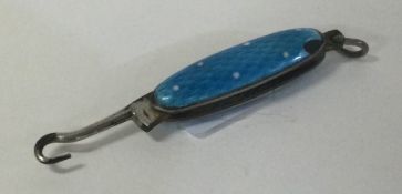 An attractive miniature enamelled button hook.