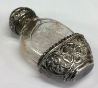 A silver and glass pepper shaker.