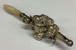 A rare silver figural rattle with MOP handle.