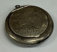 A heavy engine turned silver lady's compact.