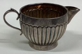 A Victorian silver fluted cream jug.