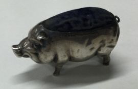 A large silver pin cushion in the form of a pig.