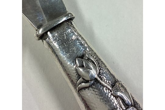 A Japanese silver shoe horn decorated with chased rose water lilies to handle. - Image 2 of 3