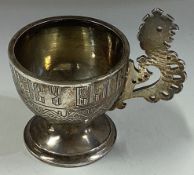 A 19th Century Russian silver vodka cup with pierced handle.
