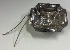 A 19th Century silver tea strainer.