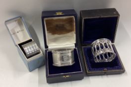 A good group of three cased silver napkin rings.
