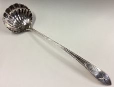 A good bright-cut silver soup ladle with fluted bowl to crested terminal in the Georgian style.