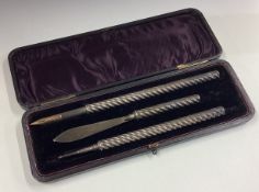 A rare cased writing set comprising of silver quill and letter opener.