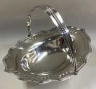 A Georgian silver swing handled basket with bright-cut decoration.