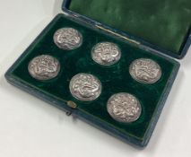 A cased set of six Continental silver buttons.