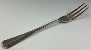 An 18th Century three-pronged silver fork.