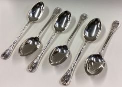 A good set of six cast silver dessert spoons with crested terminals.