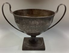A good Georgian silver panelled trophy cup with crested decoration.