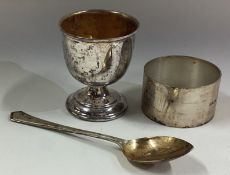 A cased silver egg cup, napkin ring and spoon set.