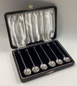An unusual set of six silver coffee spoons.