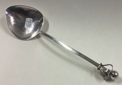 A E JONES: A stylish silver preserve spoon with ball decoration.